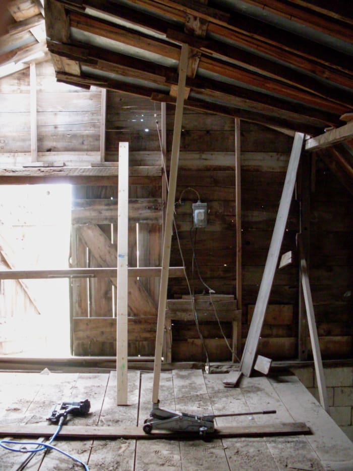 Using a 2x6 and a floor jack, we gently pushed a small section if the roof into level. We started where the roof showed the least amount of damage.