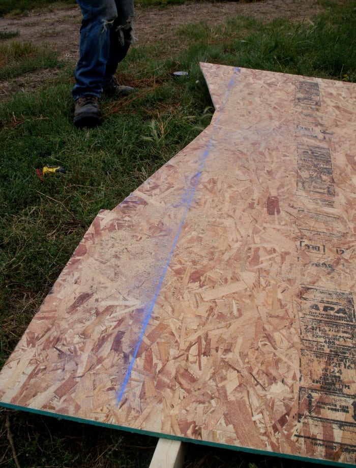 Mark a new baseline on your plywood, so that you can flip the placement of your triangle opposite of the first one. Measure how wide this brace will need to be from peak to base, to make sure your baseline is placed far enough out.