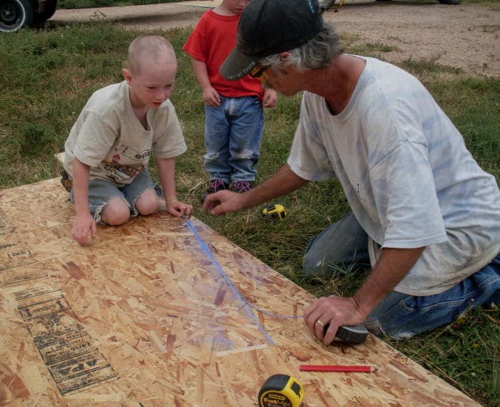 Using a chalk box to mark lines makes the process efficient, but using a large square or straight edge, and a carpenter's pencil works too.