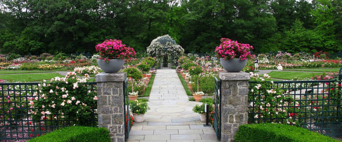 A typical garden perspective at the NY Botanical Garden entered by ornamental gateway