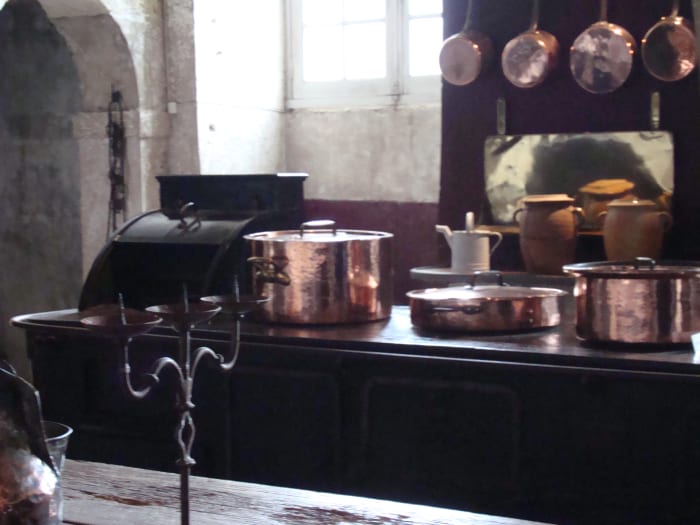 Kitchen equipped with ovens and copper utensils