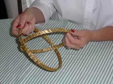Step 1: Time to fit the two embroidery hoops together, to create the mobile, and the setting for your centerpiece decoration. The embroidery hoop with the screw will be the top hoop, fit the slightly smaller hoop into the hoop with the screw.