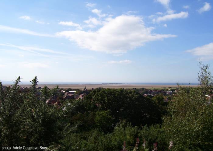 Looking from the top of Grange Hill over West Kirby village to the beach. Middle Eye and Hilbre Islands are on the horizon.