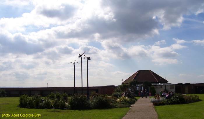 The promenade and beach are just over the wall. Benches in the circular garden, and the wobbly geese on poles were installed by the Friends of Coronation Gardens.