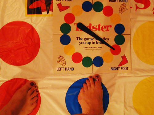 Twister gross motor challenge of motor planning, position in space and proprioception. Photo from Flickr.com.