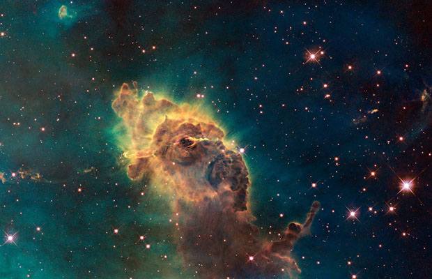 Hubble's first images of visible image of the Carina Nebula. It is composed of gas and dust and the pictured pillar resides in the tempestuous stellar nursery in the Carina Nebula, located 7500 light years in the southern constellation of Carina. Thi