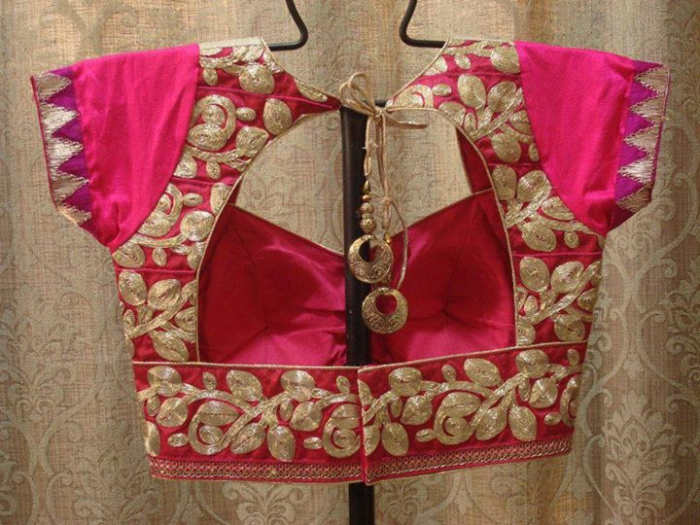 Beautiful and gorgeous hot pink blouse with a window back. Zari embroidery for the ultimate party look.