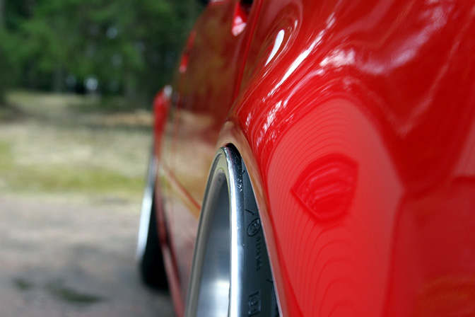 This is a mildly stretched tire. The wheel rim slightly pokes out but is still parallel and flush with the fender.
