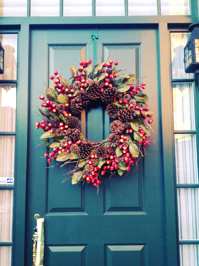 A berry wreath for the front door adds a festive touch and is perfect for holiday decor.