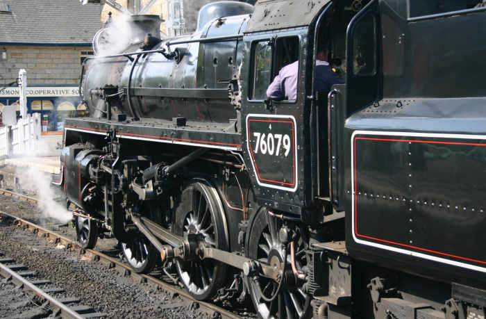 On the North Yorkshire Moors Railway at Grosmolnt with a train for Pickering, preserved 76079 simmers by the level crossing