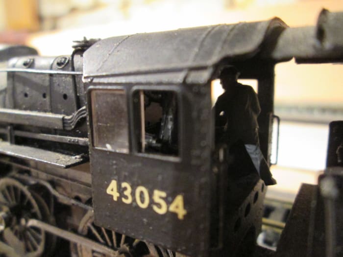 One for the rivet-counters: close-up of 43054's cab shows the fireman's busy building up her reserves before setting out. Driver's on the left, more or less invisible in this view