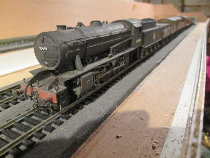 Three-quarter view of WD 2-8-0 90446 of Newport (near Middlesbrough) shed, 51B heads a mixed fitted and unfitted working from the lower deck fiddleyard