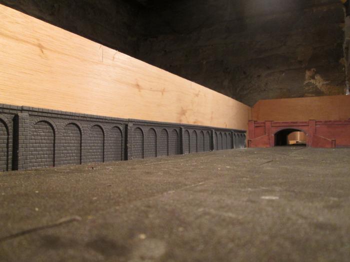 Retaining wall in place to await the next stage. See how Metcalfe low-profile terraced house-backs fir in place. Some modifications may be called for. First a backscene will have to be attached to the rear unit wall to achieve depth.