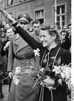 Hanna Reitsch greets well-wishers on a visit to her hometown of Hirschberg, Silesia in April, 1941. Karl Hanke, Gauleiter of Lower Silesia, is at lef