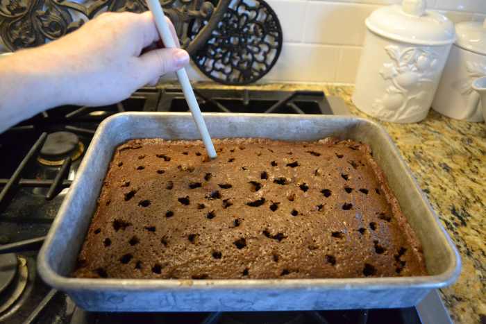 Right after taking the cake out of the oven, use the handle-end of a wooden spoon to poke holes all over the top of the cake.
