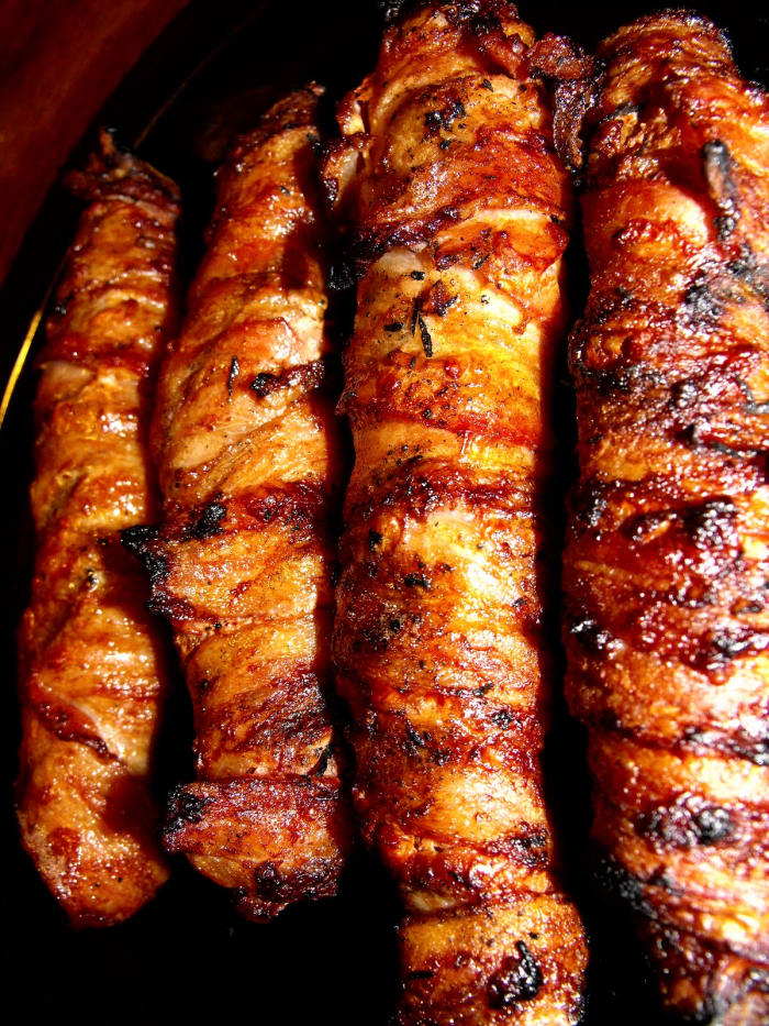 In this photo you have delicious Bacon Burger Dogs that have been grilled. And in case you're wondering yes they are delicious. Have you ever had one. They are easy to make and they are delicious.