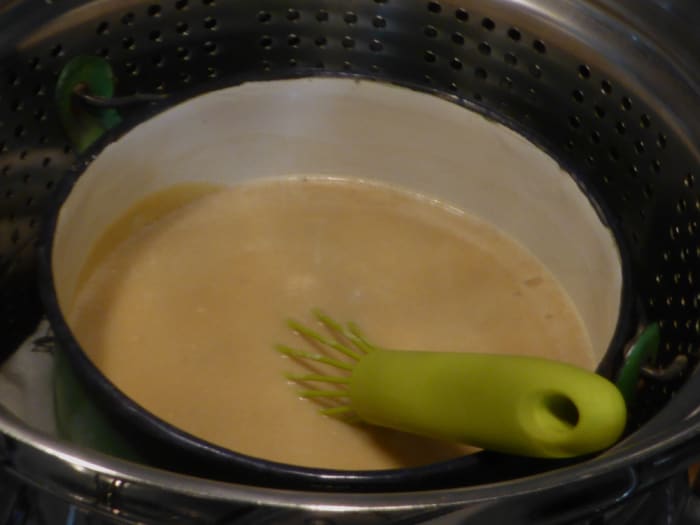 Combine the strained beaten eggs, coconut cream, and sugars in the pot with the caramel. Set the pot into the pot for steaming. Image: © Siu Ling Hui