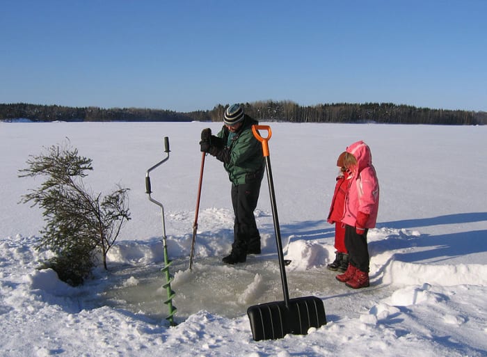 Cutting a hole in the ice when the lake is frozen.