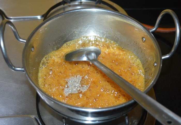Continue to stir until it becomes thicker and golden brown (5-6 minutes). Scoop a teaspoon into the mixture and drop it back into the pan. If it falls making a single thread, it is the right consistency.