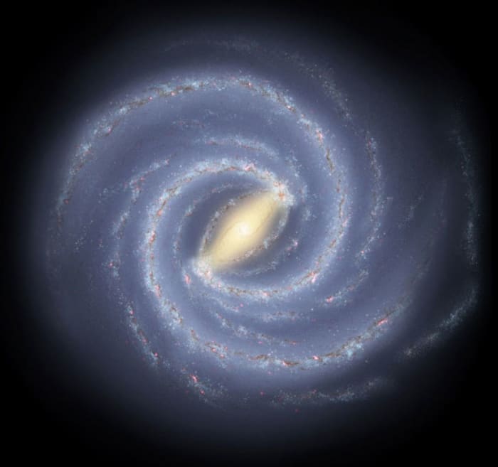 In this artist rendition we can see the milky way galaxy. Below the center and approximately four spiral arms outward, lie the sun and our solar system. Or approximately 25,000 light years from the core of the milky way