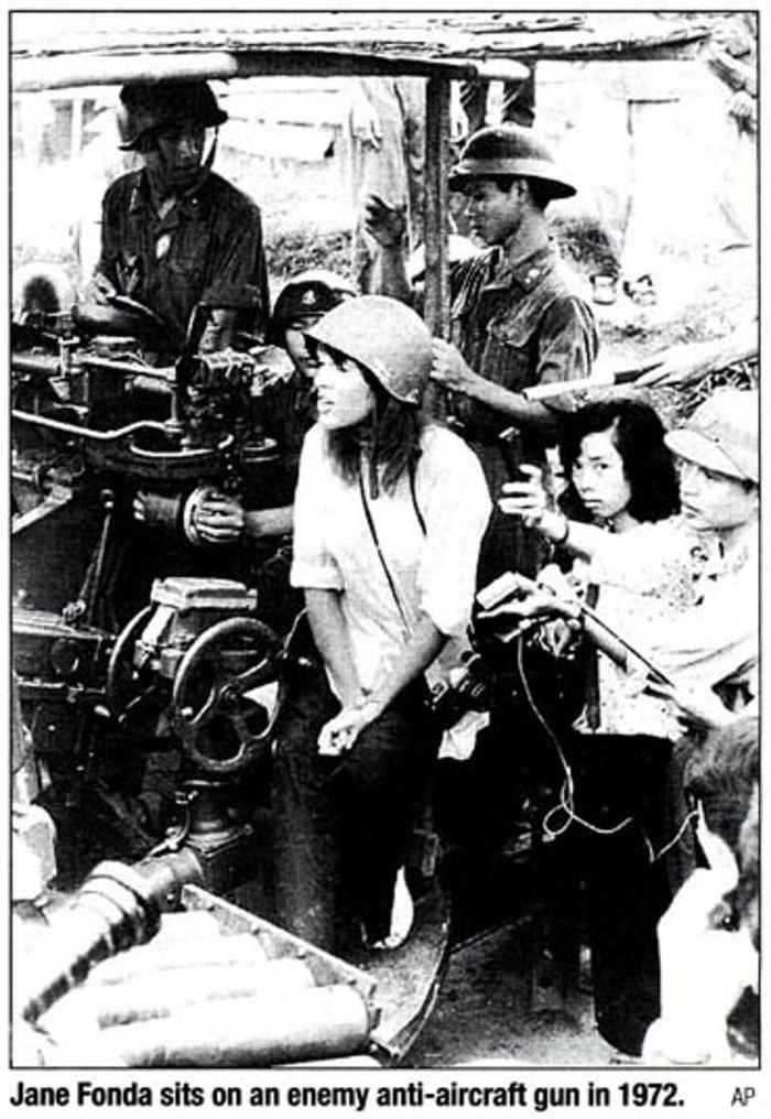 JANE FONDA PROVIDING COMMUNISTS WITH PROPAGANDA PHOTO SITTING ON COMMUNIST ANTI-AIRCRAFT GUN USED TO KILL AMERICAN PILOTS