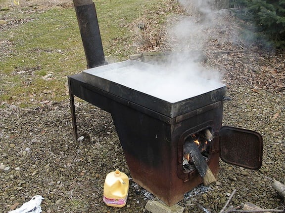 This is a typical outdoor evaporator pan heated with wood for making syrup.