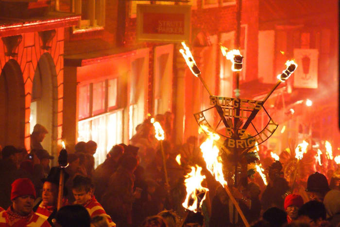 On Bonfire Night, revelers celebrate in the streets, watch fireworks, light bonfires, and burn effigies of Guy Fawkes.