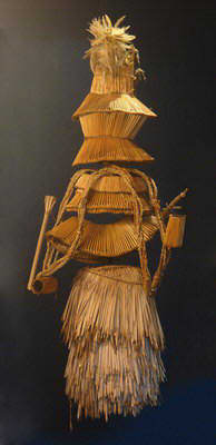 The disguise for the Venda initiates is made up of a series of grass mats wrapped around them; see picture below