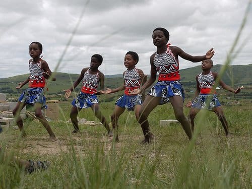 Swazi kids entertaining tourists clad in traditional garb and performing traditional and customary dances
