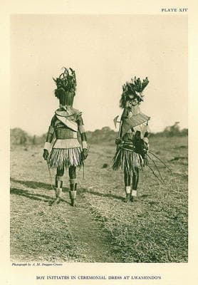 This is how the initiates for circumcision looks like. The dress abpove and the one wonr by the two men disguises them, and one here is crrying a typical old-fashined Venda battle axe