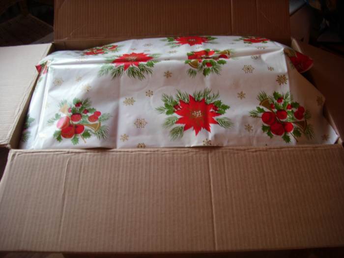 Covering the above  content of the Balikbayan Box with a plastic cloth.