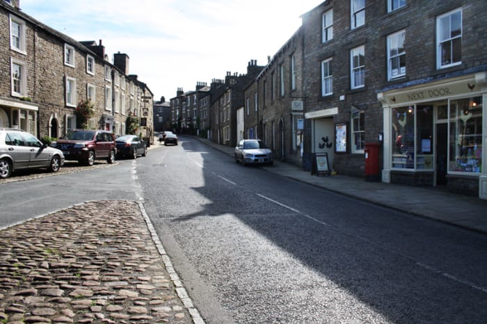 The main street in Askrigg leading down to Bainbridge where the shortest river in England - the Bain - empties under the bridge into the Ure