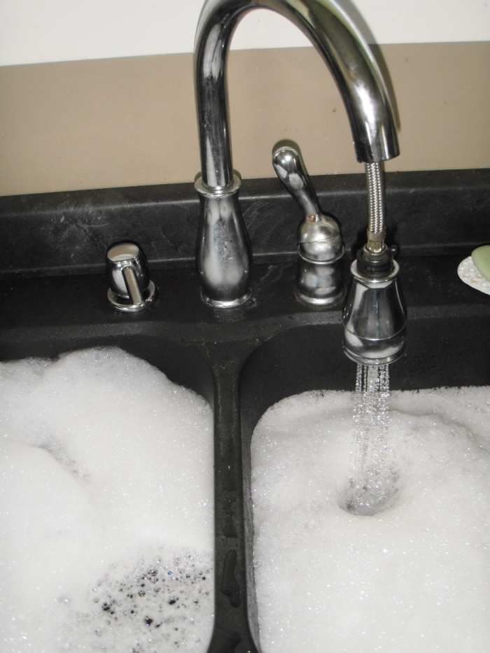 To prevent a clogged kitchen sink, on a monthly basis fill the sink or tub to the brim with hot water.