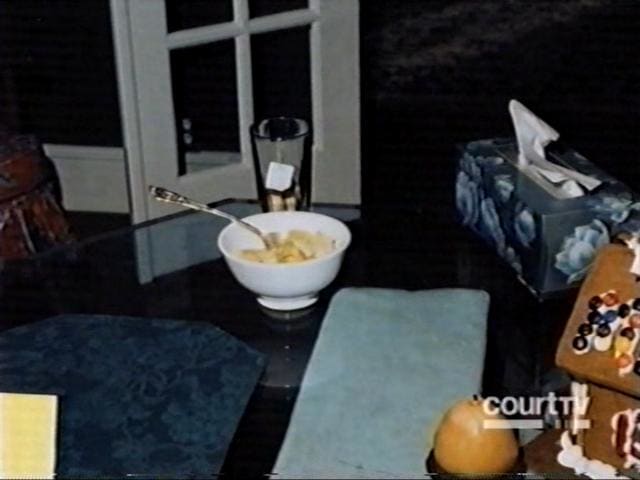 Crime scene photo of the bowl of pineapple and glass of tea found on the dining room table.