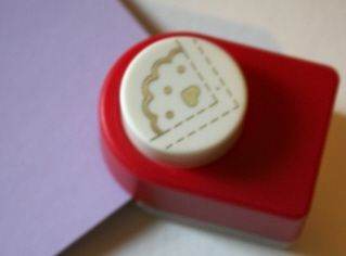 Just slide you paper into the corner of the cutter, making sure it fits snugly against the guides. Like this:
