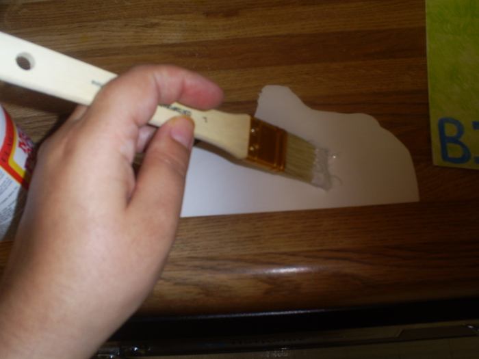 Here I am using mod-podge to attach the pop-up image to the card. Using a glue stick or double sided tape is another alternative.