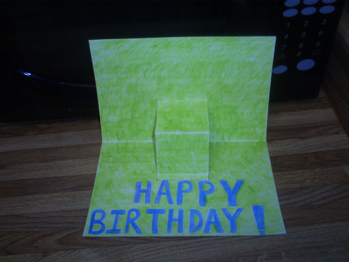 I used colored pencils to make this grassy background. Also, I sketched out Happy Birthday in pencil and colored it in with blue.