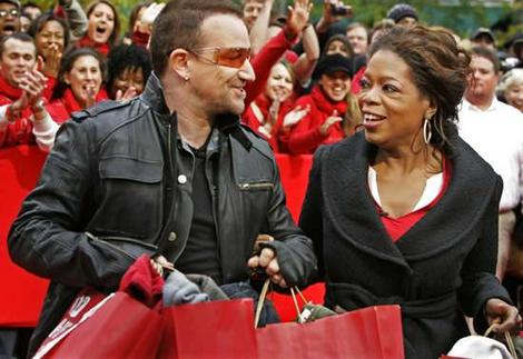Happy to give: Celebrity fundraisers Bono and Oprah Winfrey promoting the singer's new project to fight AIDS in Africa. Photo: AP