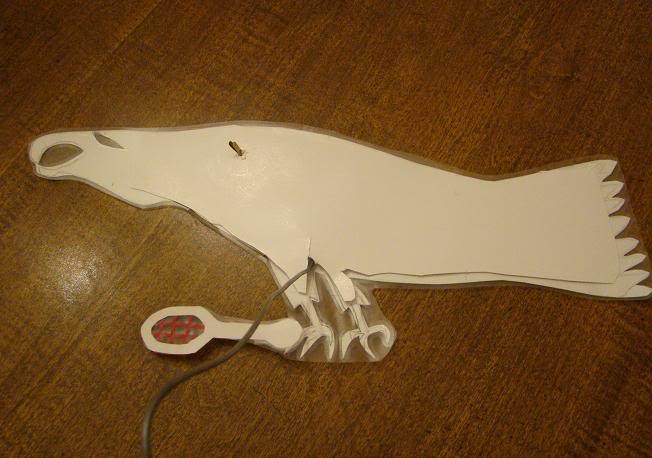 Eagle holding removable racket. During part of the play, the characters needed to be holding rackets, so we attached the rackets with a small ball of tape rolled sticky side out.