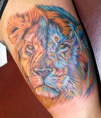 The addition of the blue adds interest to this tattoo. The artist captured the wildness and magnificence of lions well.