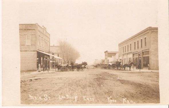 His description of the scene: Downtown Main Street looking east. The IOOF bldg is n left forefront and the hotel is east of it. The Deuel store is in right forefront.