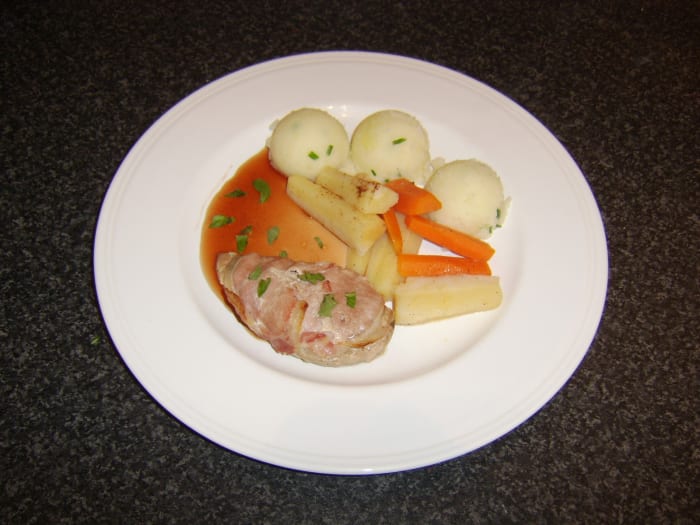 Pheasant breast fillet wrapped in bacon, served with redcurrant and apple cider sauce, carrots, parsnips and mashed potatoes
