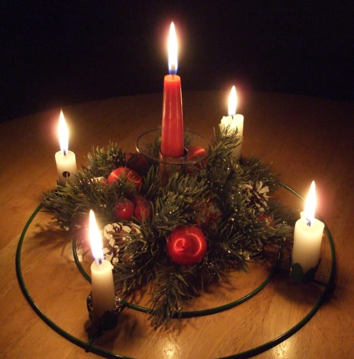 The plastic wreath of winter greens is a decorative touch for the Advent supplies, but not liturgically needed. In this photo my center candle is in a candleholder, but in the past it was often secured in a short glass with crumpled aluminum foil.