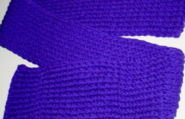 Purple scarf done with the figure 8 wrap on the pink Knifty Knitter loom. TWO strands of Red Heart Super Saver yarn were used to make a denser, heavier scarf.