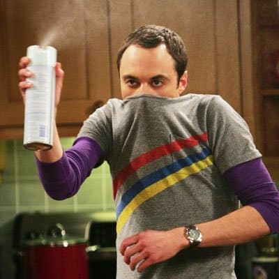 Sheldon is extremely afraid of falling sick and is paranoid about going near anyone who is sick or anything that can make him sick, hence the bug spray in this picture.
