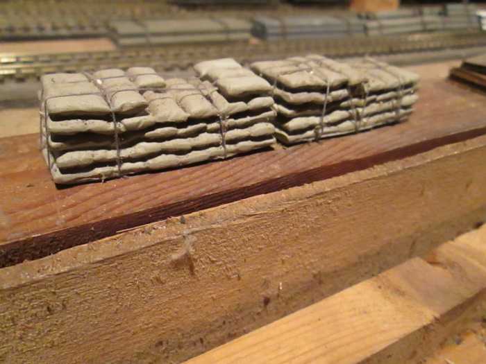 'Roped' cement bag loads - resin castings with darning cotton. I chopped up the castings a bit and glued some 'bags' on top
