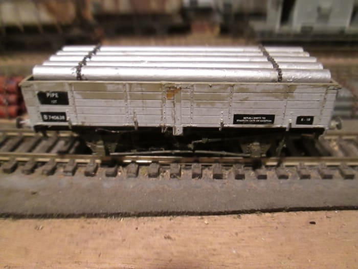 Brass chain on silver-painted plastic pipe load fills this drop-sided BR Pipe Wagon. Parkside kit with Smiths' 3-link couplings and Alan Gibson steel sprung buffer-heads to replace the plastic moulding