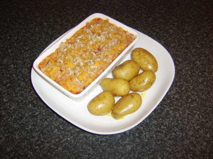 Succulent white fish in a rich tomato sauce is topped with cheese and breadcrumbs and served with dill buttered new potatoes
