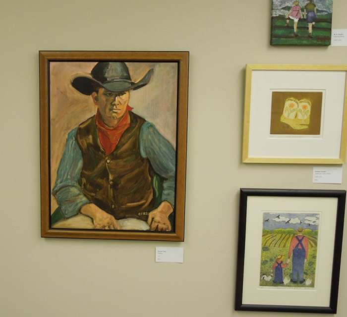 I call this the western wall. The two paintings above were also on it. To the left is "Cowboy" by Carmen Fojo, in oils. At the lower right is "Grandfather's Fields" by Earlene Vaughn, intaglio print.