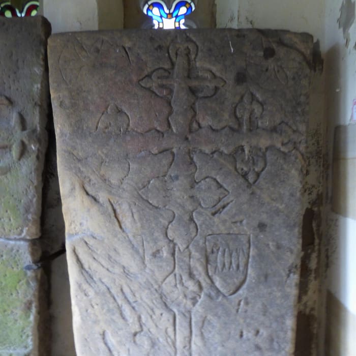 Ornate slabs in the church porch are in fact coffin lids of the Percy family, whose lands extended across the North and North East, and who were involved with the Pigrimage of Grace (to the west near Northallerton)